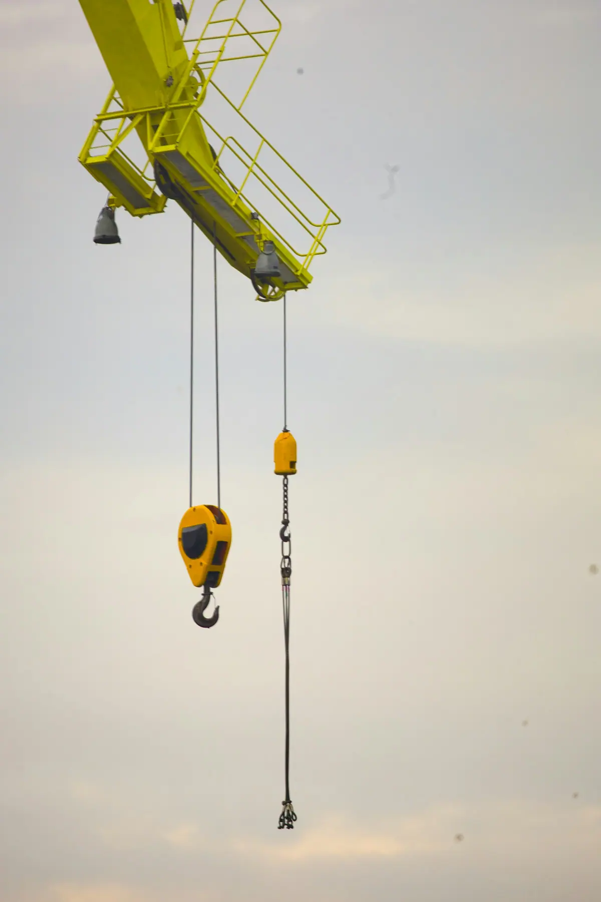 An overhead crane lifting an industrial load inside a plant